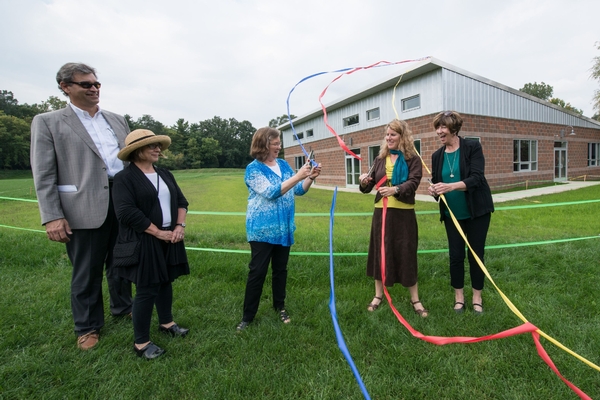 Group of teacher at ribbon cutting for new middle school building