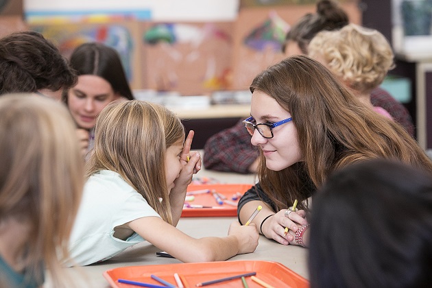 Young girl pointing at older girl