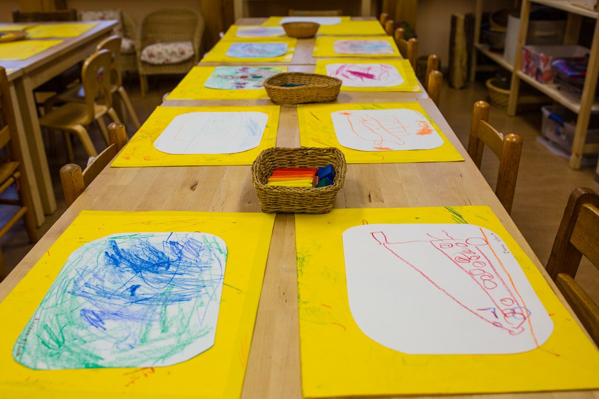 Table with Early Childhood Drawing Paper and Crayons