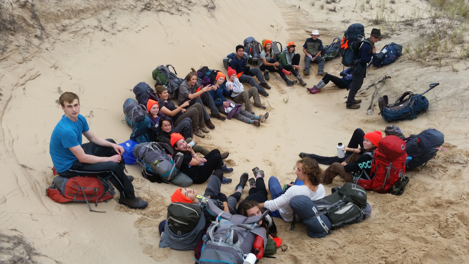 Hiking Club Laying on Beach