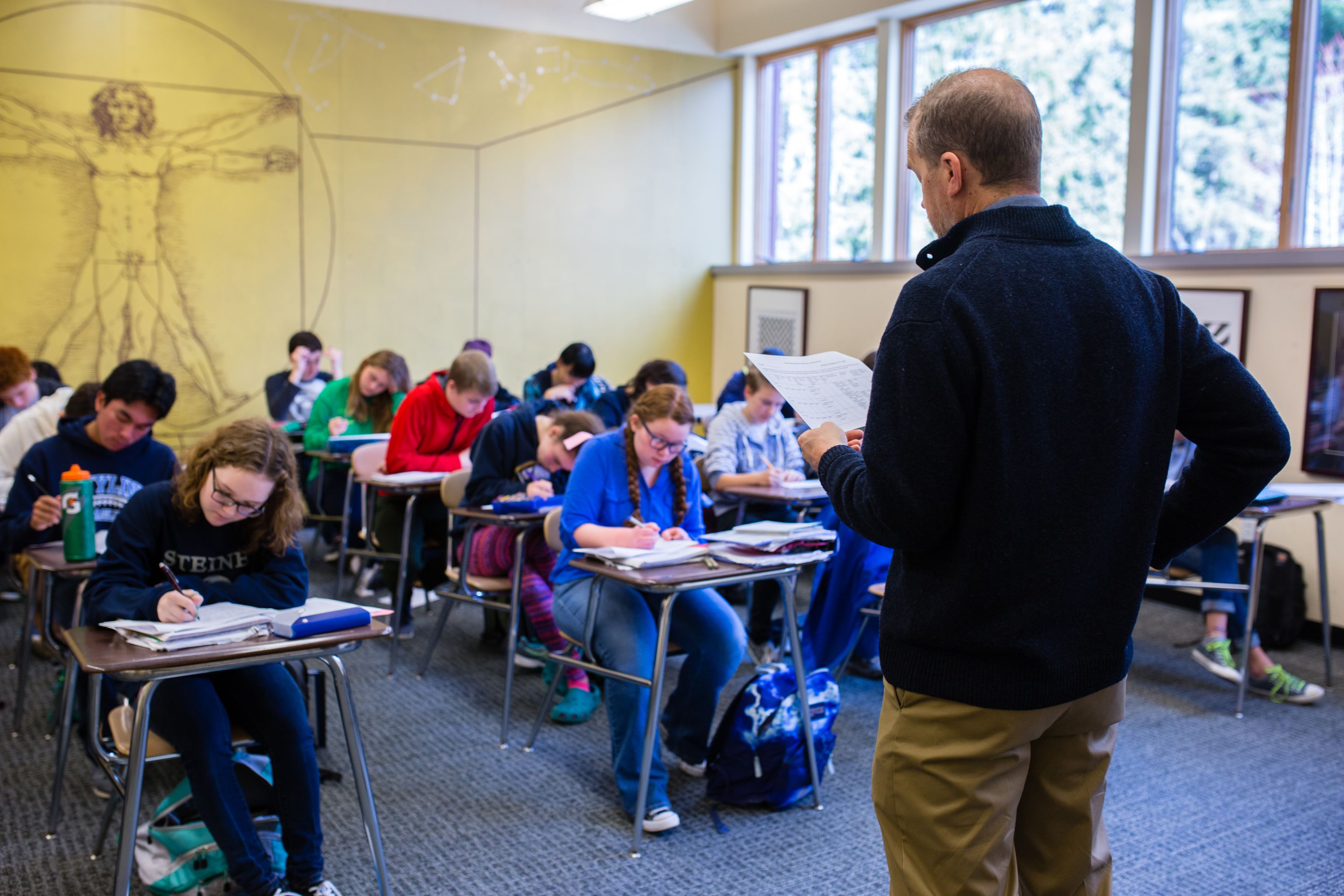 Male teacher standing in front of class