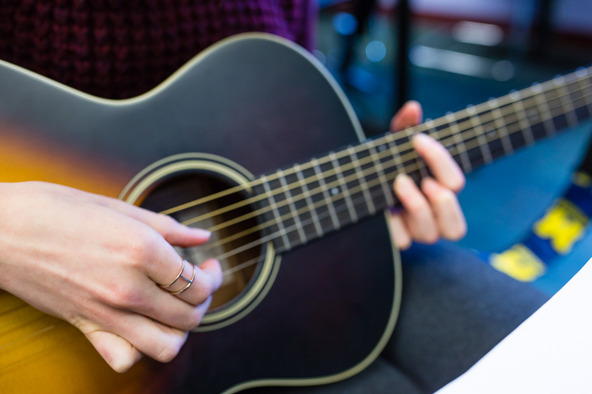 Person strumming guitar