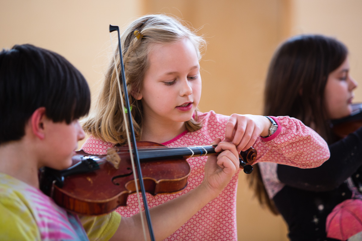 Student helping Tune Violin