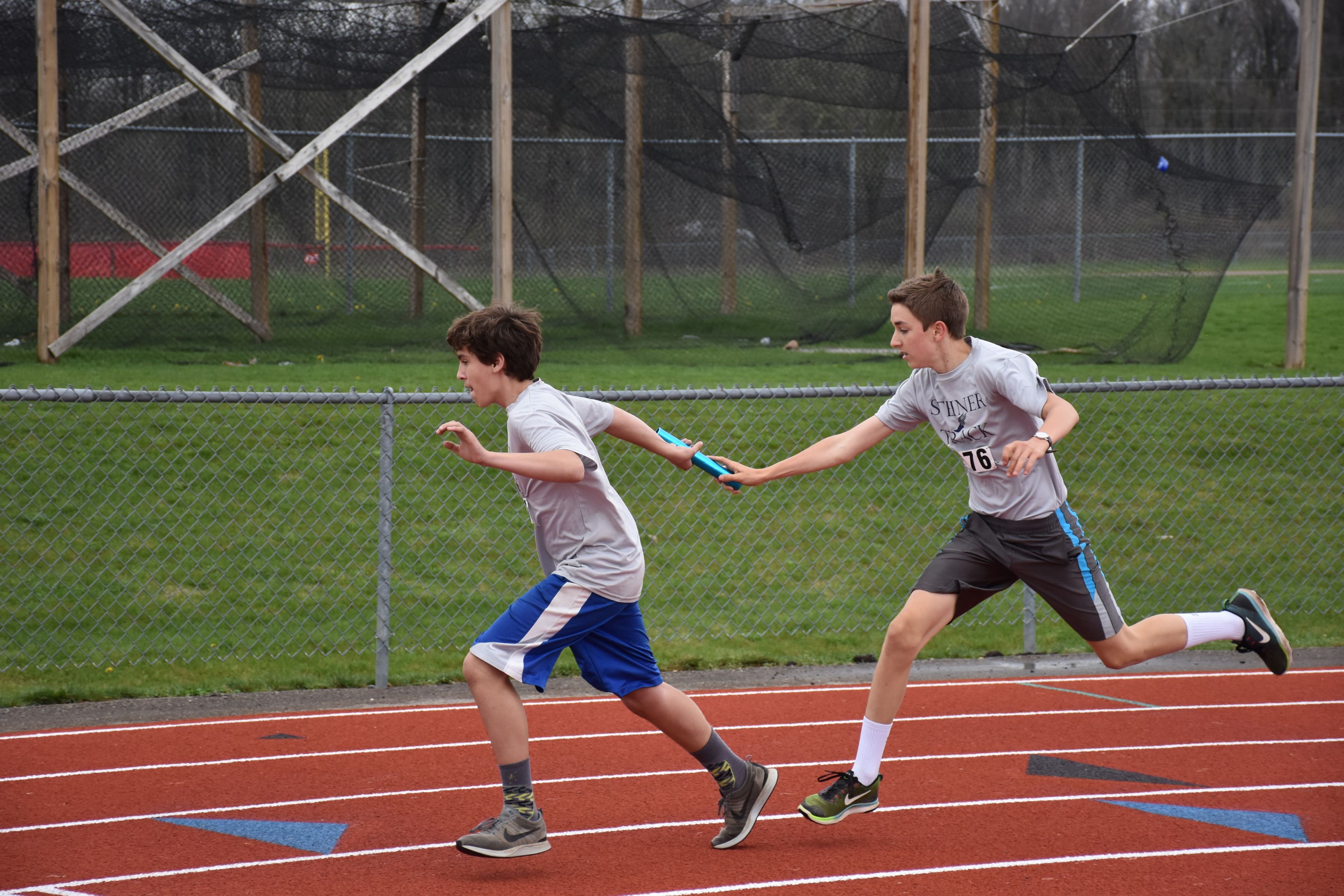 Two Boys Running Relay Race