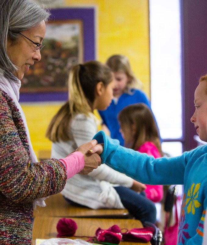 Teacher and student shaking hands